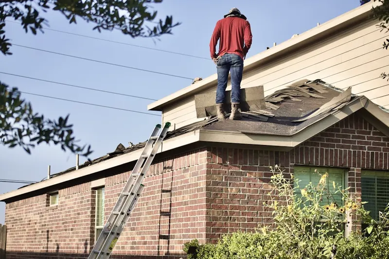 Professional roofer working on a residential roof in Fort Myers Beach
